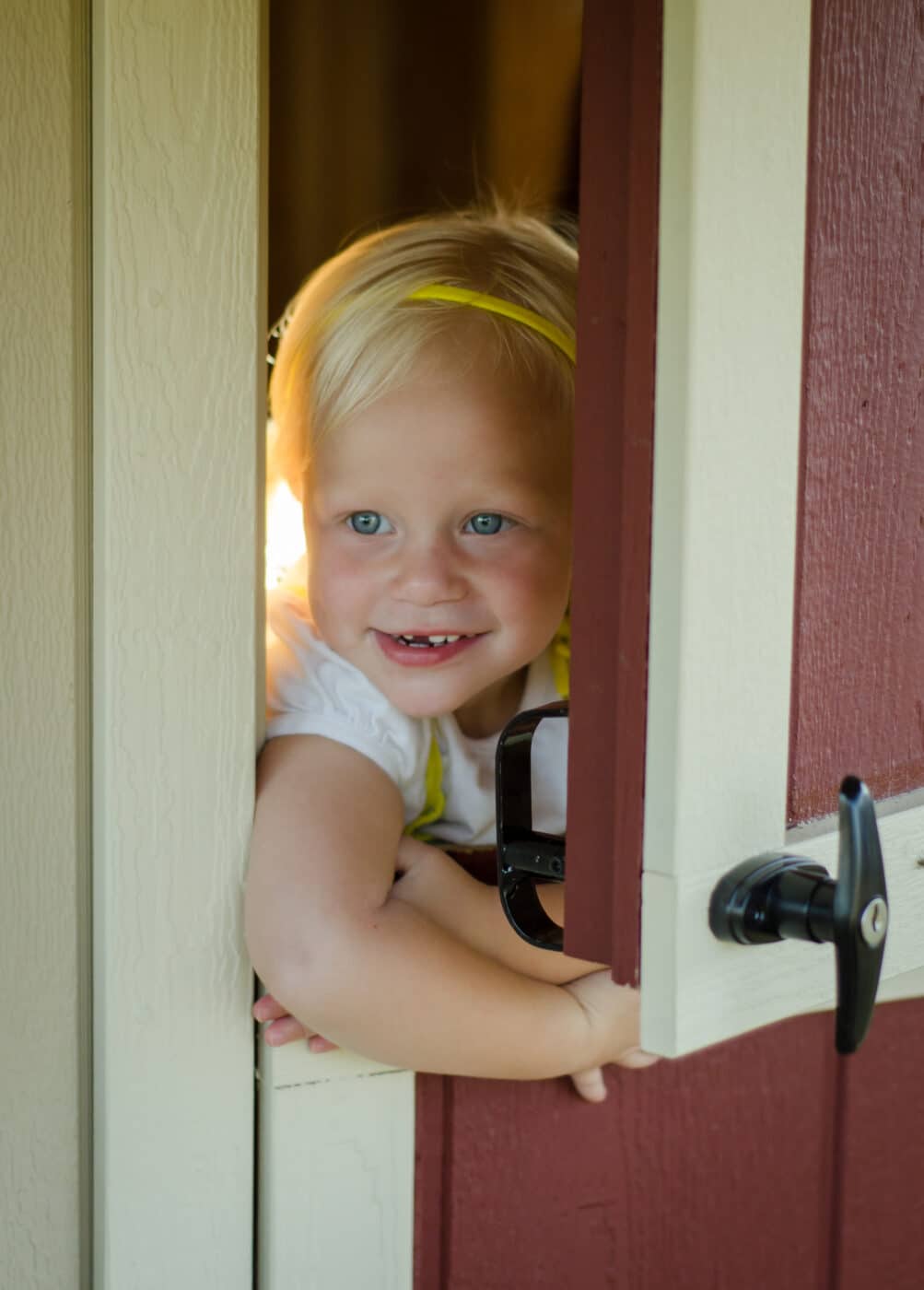 child opening door in kids playhouses for sale in texas